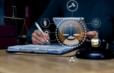 Concepts of Law and Legal services.	Lawyer woman working with digital tablet and law interface icons at table office.