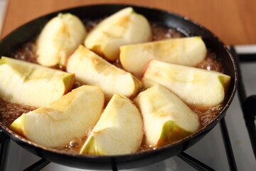 Cooking apple quarters on gas oven. Making Apple Tarte Tatin with Cinnamon Series.