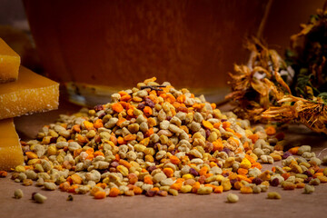 Close up bee pollen, bee wax, dried flowers and honey 