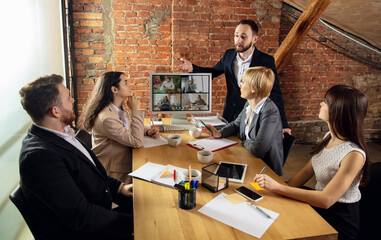 Possibility. Young people talking, working in videoconference with colleagues, co-workers at office...