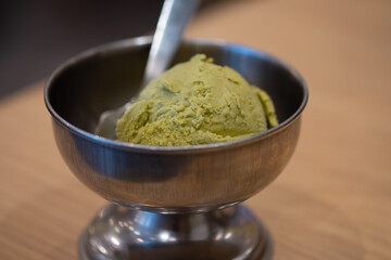 Green tea ice cream scoop in aluminum cup