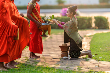 beautiful woman in ancient Lao national costume Who are ready to make merit