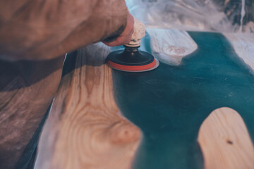 man polishing epoxy table. Epoxy furniture