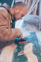 man polishing epoxy table. Epoxy furniture