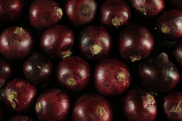 sweet red onions on background