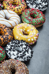 delicious assortment of donuts with icing and different fillings on the table
