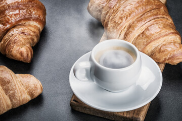 freshly baked croissants and a Cup of coffee on the table