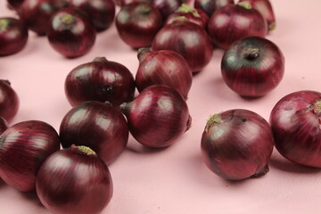 sweet red onions on background
