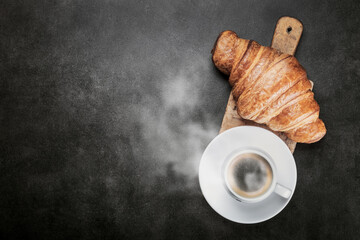 freshly baked croissants and a Cup of coffee on the table