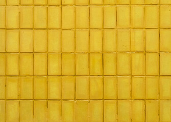Background of yellow tile wall.