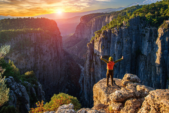 A man meets the sun on the steep slope of the Tazy canyon. Turkey