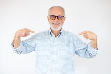 Senior handsome man wearing casual shirt and glasses over isolated white background looking confident with smile on face, pointing oneself with fingers proud and happy.