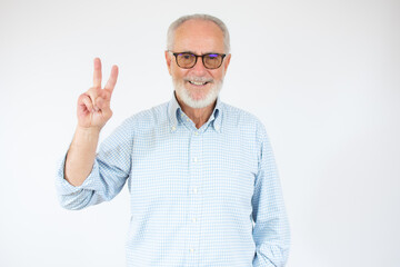Senior grey-haired man wearing casual shirt standing over isolated white background smiling with...