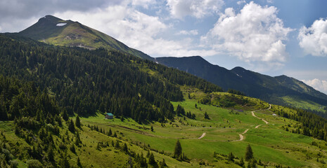 Fototapeta na wymiar Panoramic landscape of Marmaros (Maramures) mountain range with Pip Ivan Marmarosky mountain and valley in bottom