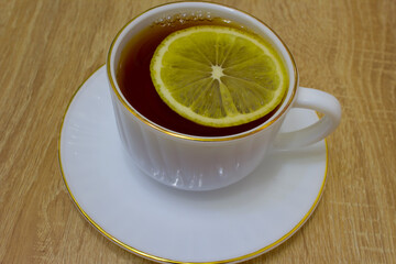 tea in a cup and a piece
of lemon