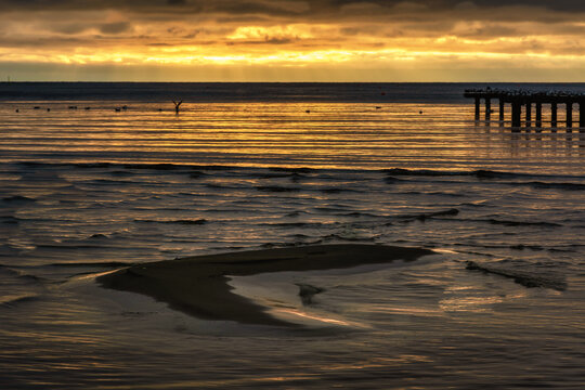A sand bar with a beautiful ocean sunset in the background. Photo from Hallevik, Blekinge county, Sweden