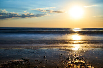 Sea sunset. Quiet calm sea. Sand beach.