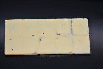 white chocolate on a black acrylic background