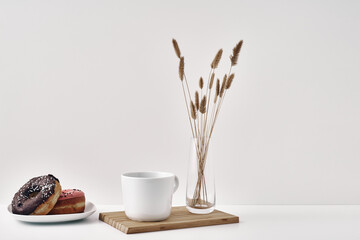 Mug and donuts cakes on a white background. Confectionery, coffee shop. Copy space, mock up