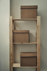 Paper boxes are on a wooden rack. Archive storage, use of eco-friendly materials