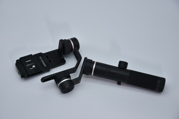 Black ghimbal video capture equipment are mounted on a 3-axis motor stabilizer for smooth video...