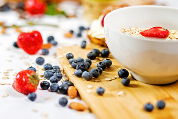 Oatmeal with fresh berries in a bowl on the Board