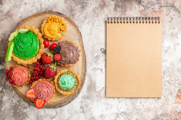 top view delicious cream cakes with fruits on a light background biscuit sweet dessert cake