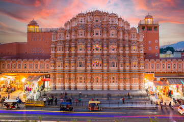 Stunning view of the Hawa Mahal at sunset with blurred people walking during the Covid-19...