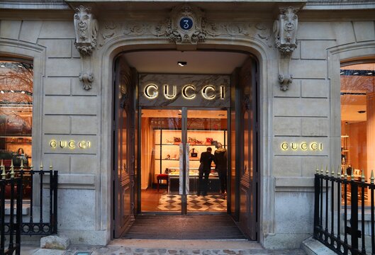 PARIS, FRANCE - DECEMBER 10, 2019: People shop at Gucci fashion store in Avenue Montaigne Paris, France. Avenue Montaigne is one of most upscale fashion shopping streets in Europe.