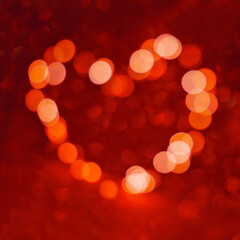 Valentine's Day background, bokeh red heart. Red glitter sparkle confetti. Invitation to the Happy birthday party.