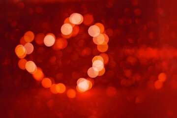 Valentine's Day background, bokeh red heart. Red glitter sparkle confetti. Invitation to the Happy birthday party.