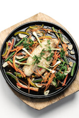 chinese style steamed fish fillet with vegetables on hot plate