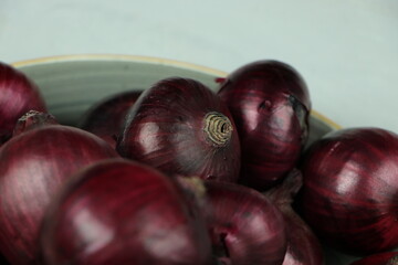sweet red onions on background