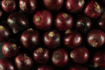 sweet red onions on background