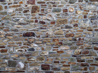 Part of an old stone wall, pointed with mortar, for background or texture.
