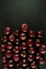 sweet red onions on background