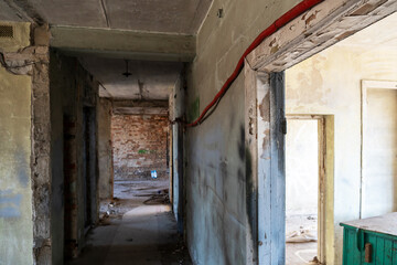 Renovation in the apartment. Destroyed buildings after an earthquake or cataclysm. Walls without plaster and broken red brick. Lack of windows and doors in abandoned apartments.