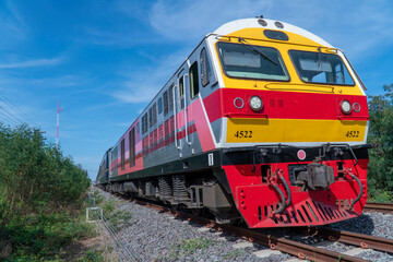 Thailand Locomotive train on the railroad tracks with blue sky.