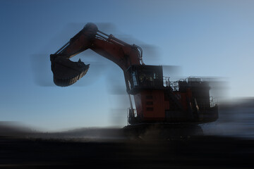 blurred view of big excavator at worksite of coal mine