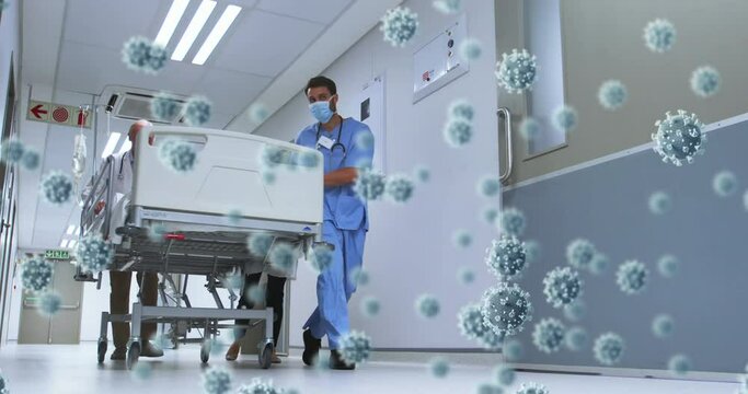 Digital composite video of covid-19 cells floating against male doctor and male medical professional