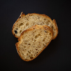 Fresh sliced ​​bread on a black background. View from above.