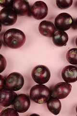 sweet red onions on background
