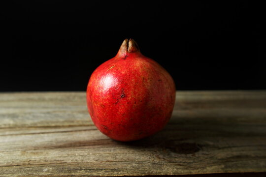 fresh red pomegranate isolated in black background