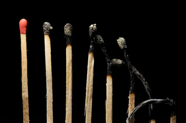 burning a match with a black background