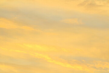 Sun below the horizon and clouds in the fiery dramatic orange sky at sunset or dawn backlit by the sun. Place for text and design