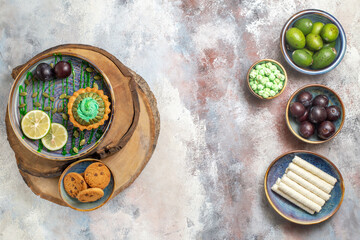 top view little creamy cake with fruits on light background photo biscuit candy sweet