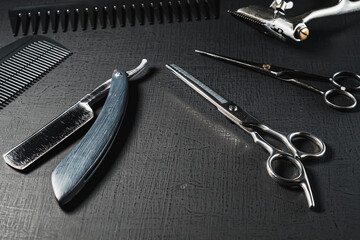 vintage barber tools. dangerous razor, hairdressing scissors, old manual clipper, combs, shaving brush. black monochrome