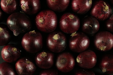 sweet red onions on background
