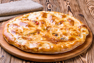 Ossetian pie with meat and mushrooms and vegetables