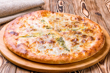 khachapuri with spinach on wooden table